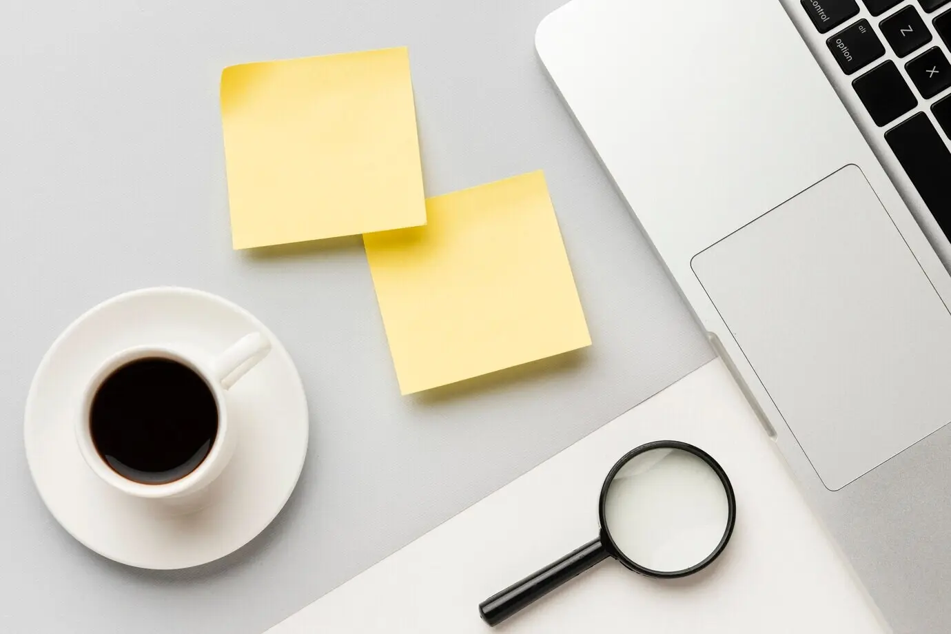 Overhead view of an office desk setup with yellow post-its.
