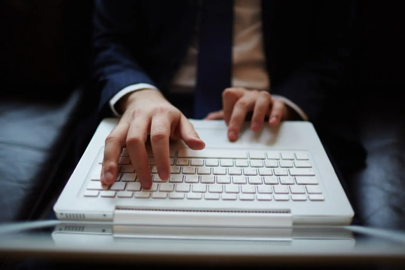 A close-up view of hands on a keyboard