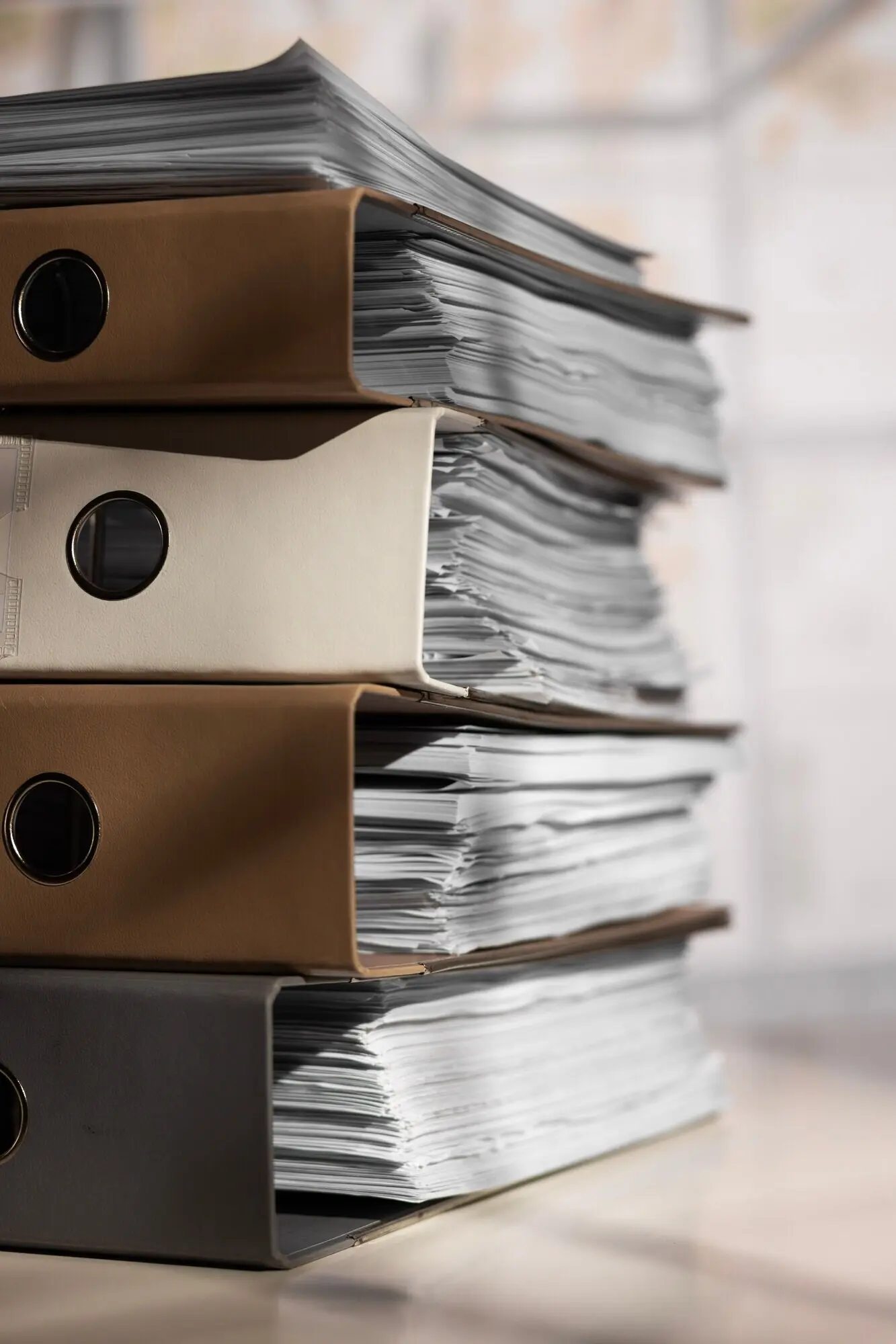 A still life depicting a stack of documents.